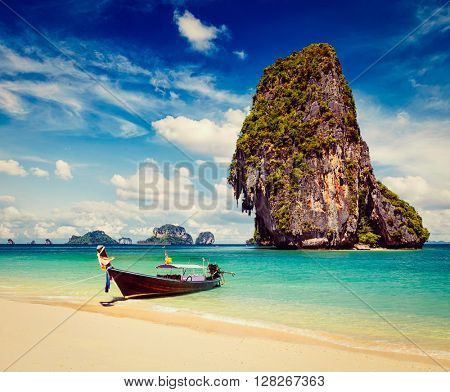 Thailand tropical vacation concept background - Vintage retro effect filtered hipster style image of long tail boat on tropical beach with limestone rock, Krabi, Thailand