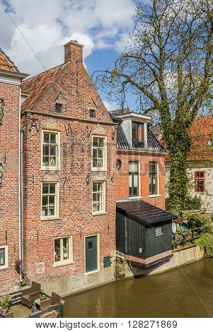 Old houses along a canal in Appingedam Netherlands