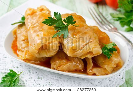 Stuffed cabbage rolls with rice and meat in tomato sauce
