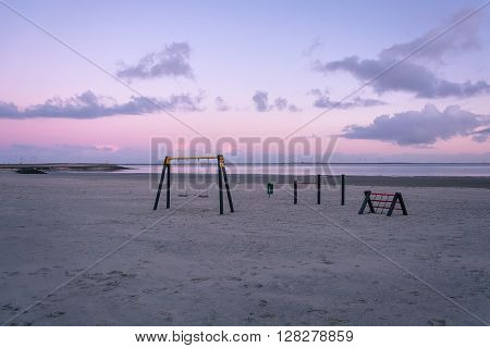 Purple dawn and playground on the banks of the bay.