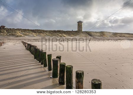 Water old tower in the dunes by the sea.