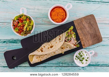 Tortilla with pulled pork, fresh vegetables
