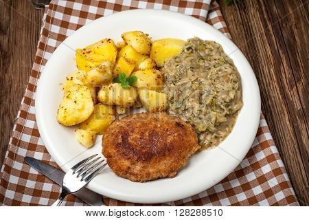 Delicious Meal Of Minced Meat Cutlet, Potatoes And Fried Cabbage.