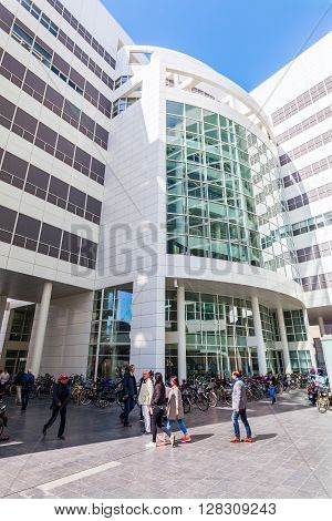 The Hague Netherlands - April 21 2016: New City Hall of The Hague with unidentified people. It was designed in 1986 by American architect Richard Meier and completed in 1995