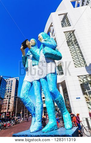 The Hague Netherlands - April 21 2016: sculpture in front of the New City Hall of The Hague with unidentified people. It was designed in 1986 by American architect Richard Meier and completed 1995