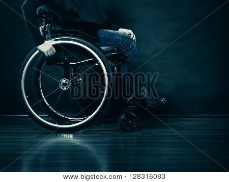 Real people disability and handicap concept. Young woman invalid girl sitting on wheelchair part of body studio shot on black