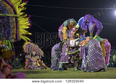 BAMNIA PURULIA WEST BENGAL INDIA - DECEMBER 23RD 2015 : Masked Dancers performing at Chhau Dance festival at night. Shot under colored light. It is a popular local Indian tribal martial dance based on Hindu myth.