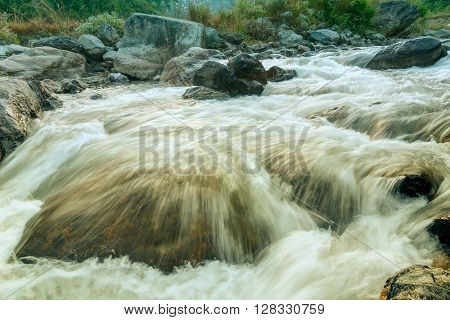Beautiful Reshi River water flowing through stones and rocks at dawn Sikkim India. Reshi is one of the most famous rivers of Sikkim flowing through the state and serving water to many local people.