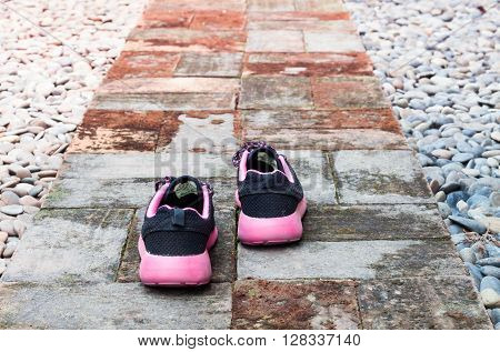 Running shoes in home garden foot path, stock photo