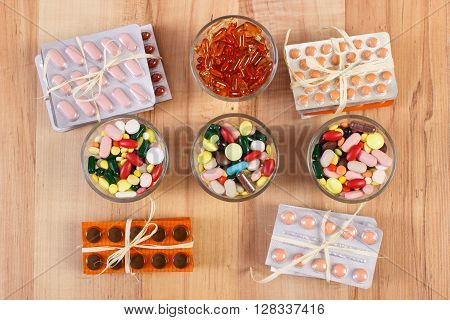 Colorful medical pills and capsules for therapy and blisters of tablets or supplements concept of treatment and health care
