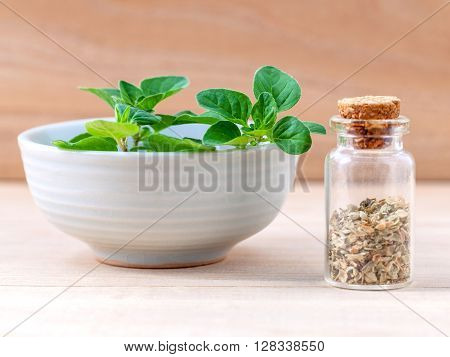 Fresh Oregano And Oregano Dried In A The Bottle With Shallow Depth Of Field Setup On Wooden Backgrou