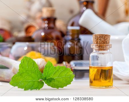 Fresh Green Mint And Essential Oil With Shallow Depth Of Field Setup On Wooden Background .