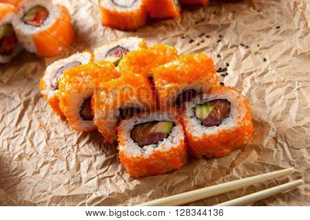 Maki Sushi with Masago  - Roll made of Fresh Raw Salmon, Avocado inside. Masago (smelt roe) outside