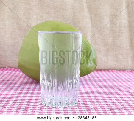 Healthy drink tender coconut water in a glass cup.