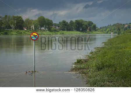 Polnad Kraków flooded Vistula/Wisła river embankments no swimming sign over the water