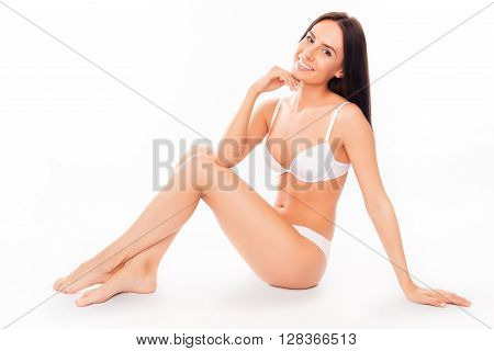 Portrait Of Sexy Brunette In White Underwear Sitting On White Background