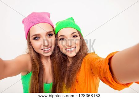 Happy Smiling Girls In Color Hats Making Selfie