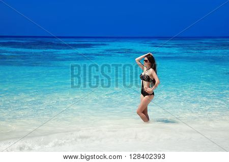 Beautiful Fashion Bikini Girl Model Tanned On Tropical Beach. Outdoor Portrait Of Slim Brunette Woma