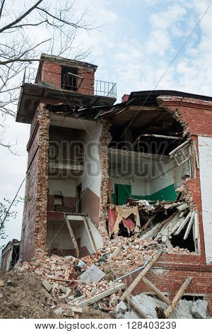 Demolition of buildings in urban environments. House in ruins.