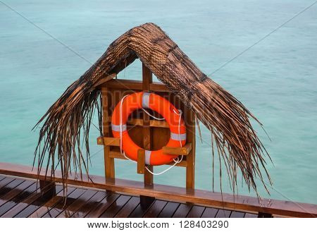 Lifebuoy near blue water rain and cloudy weather
