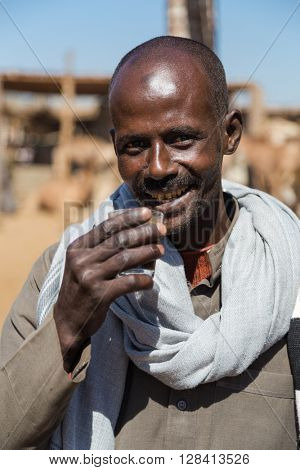 DARAW, EGYPT - FEBRUARY 6, 2016: Portrait of camel salesman drinking from glass at Camel market.
