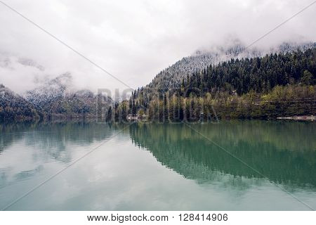 panorama left-to-right Ritsa lake in the spring morning, with clouds and blue water