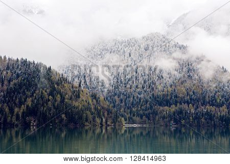 panorama left-to-right Ritsa lake in the spring morning, with clouds and blue water