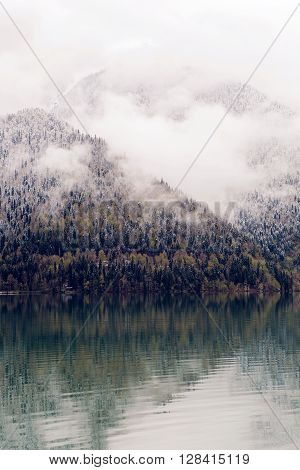 panorama left-to-right Ritsa lake in the spring morning, with clouds and blue water