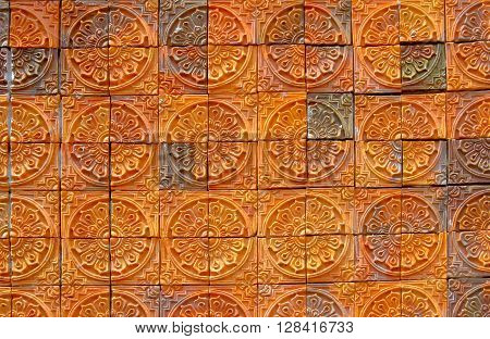 pattern background made of clay fired to a porous state that can be made impervious to liquids by the use of a glaze.