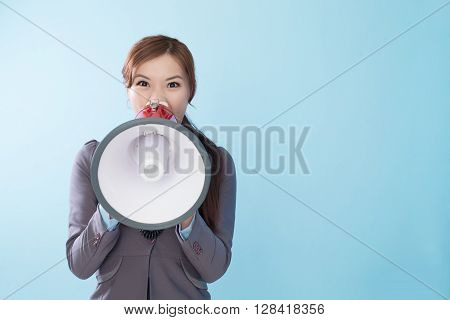 Business woman happy with a megaphone isolated on blue background model is a asian beauty