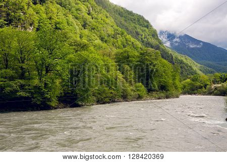 rapid mountain river in Abkhazia in the spring morning, with mountains