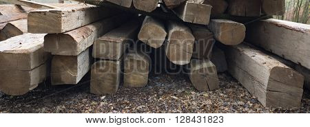 Wooden beams. Perspective composition with long beams. Exterior scene with building material. Roof building wooden components. Carpentery beam.