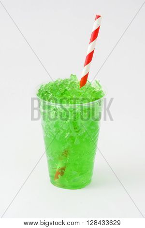 Green summer slushie on white wooden table