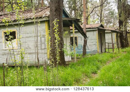 Old ruined wooden tourist cabins in the woods