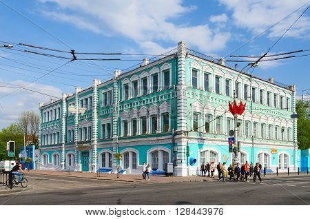 GOMEL BELARUS - May 1 2016: Unidentified people go near building of Public corporation Polespechat on Street Sovetskaya. Built in eighties of XIX century by architect E.K.Torlin before revolution - building of City Duma