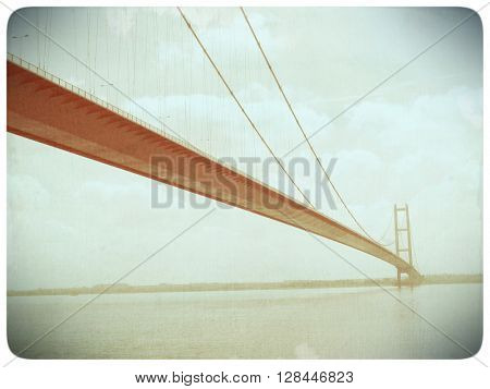 Faded old film effect applied to image suspension bridge over the River Humber