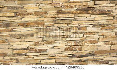 a wall of a wild yellow decorative stone