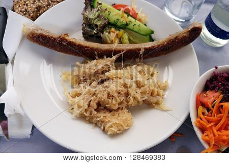 PENTLING, GERMANY - JUNE 07: Sausage with cabbage, highway restaurant in Pentling, Germany on June 07, 2015.