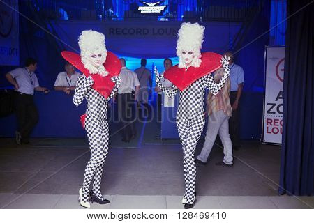 RUSSIA, MOSCOW - JUN 12, 2015: Actors dressed for performance pose in front of entry to hall of Sensation Wicked Wonderland show at Olympiysky sports complex.