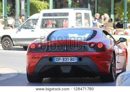 Monte-Carlo Monaco - March 9 2016: Red Ferrari 430 Scuderia (rear view) Parked in Front of the Monte-Carlo Casino in Monaco