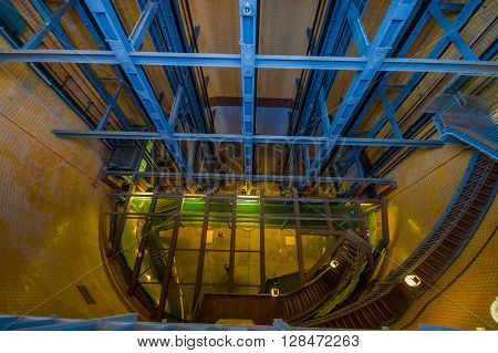 HAMBURG, GERMANY - JUNE 08, 2015: Old stain stairs behind elevators, blue structure and some lights on the way down. Elbtunnel on Hamburg