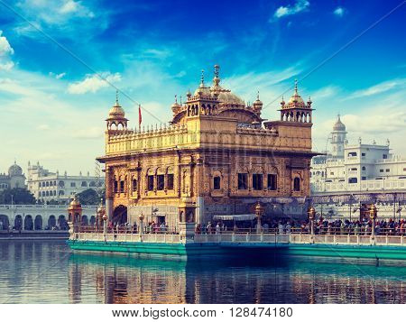 Vintage retro effect filtered hipster style image of famous indian toursit landmark and sacred pilgrimage site - Sikh gurdwara Golden Temple (Harmandir Sahib). Amritsar, Punjab, India