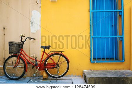 a bike against the yellow old wall