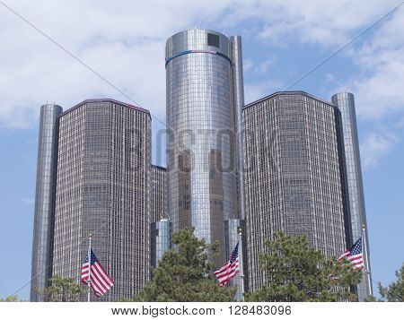 DETROIT, MICHIGAN - May 3, 2016. Three American flags fly in front of the towers of the landmark Renaissance Center, which is also known as the RenCen.