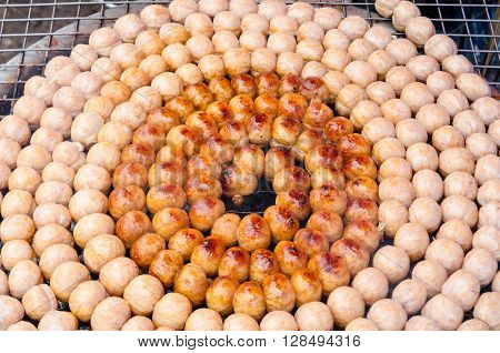 Traditional Thai Food,Sausage Northeastern Thai Style, Grilled-Isaan Sausage on steel mesh, Thai pork mix rice sausage grilled in Thailand.
