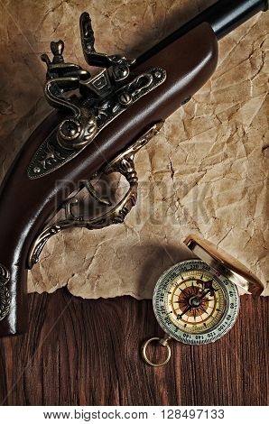 Ancient Pistol And Brass Compass