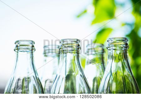 Glass Bottles Over The Sunny Background