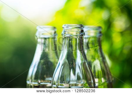 Glass Bottles Over The Sunny Background