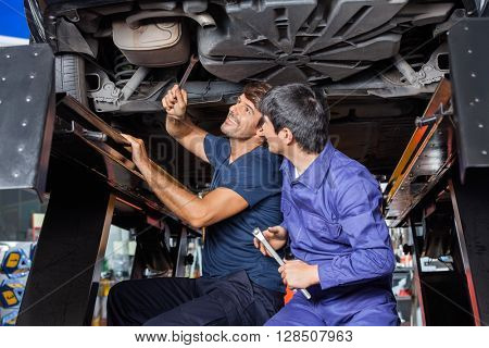 Mechanics Working Under Car
