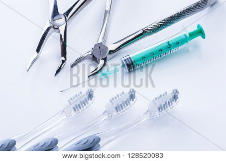 Basic dental tools on a white surface